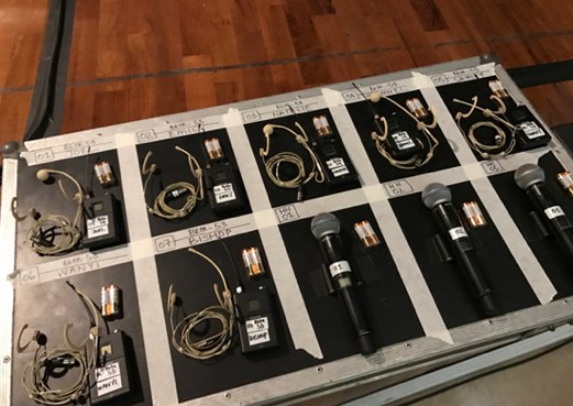 Wireless microphones prepped in a case for an Easter Musical