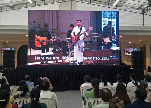 LED screen showing the live service in a church overflow hall