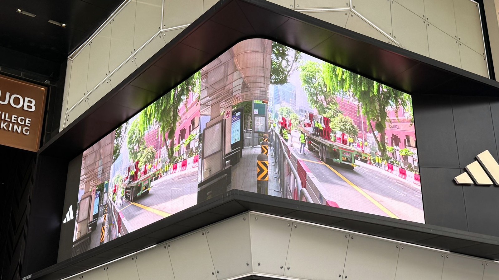 LED wall at an Orchard Road store, Singapore, showing a live camera feed of the road for the event livestream