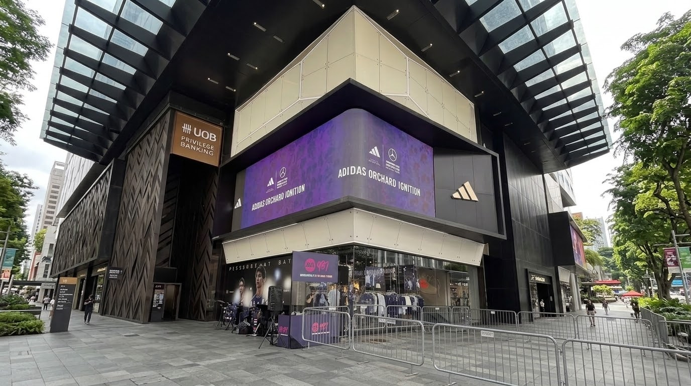 LED screen on the corner of a flagship store on Orchard Road, Singapore, showing the event branding for the live production
